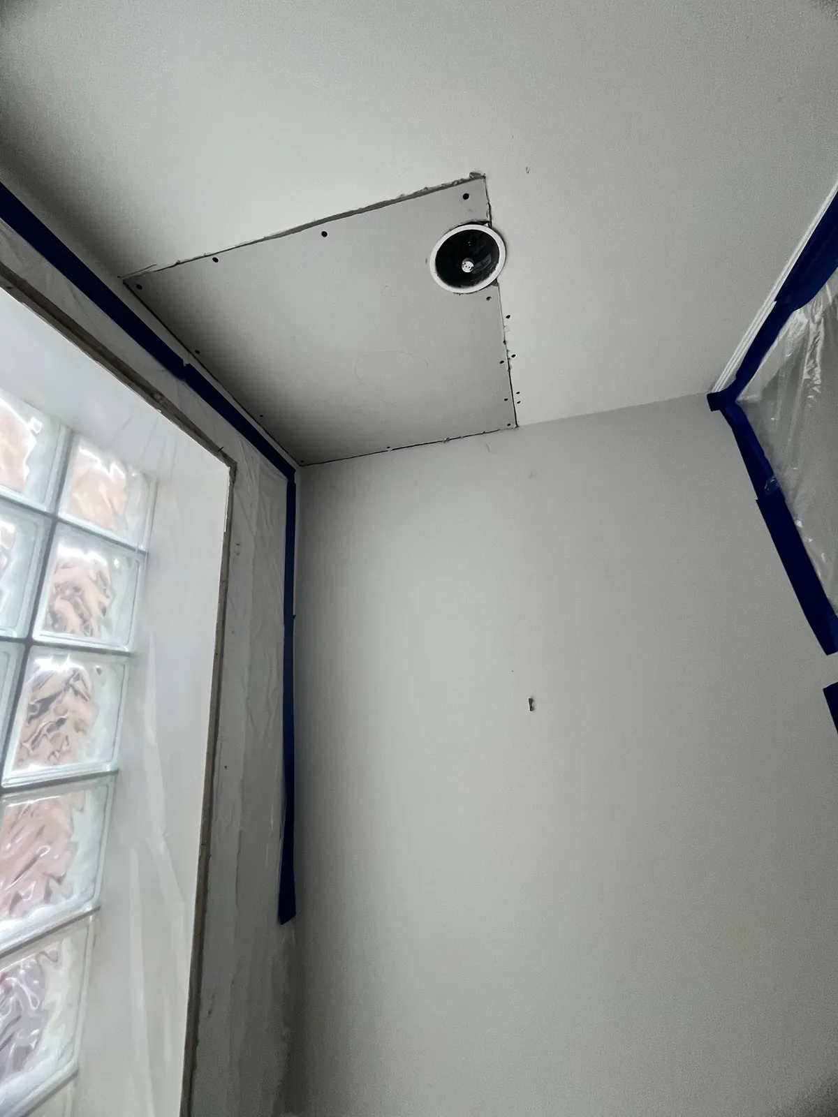 Ceiling drywall patch installed around pot light