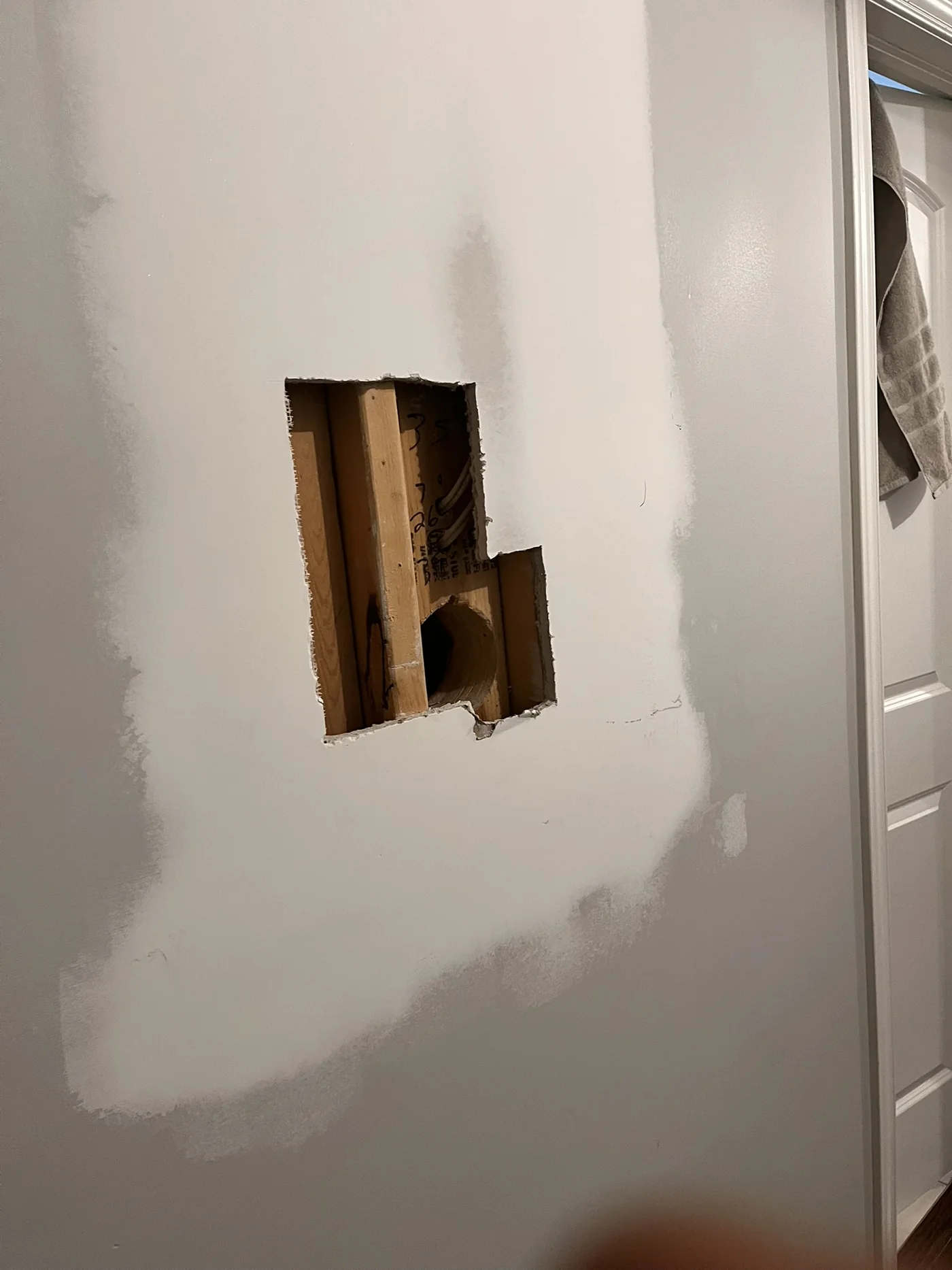 Hallway wall opening before drywall repair