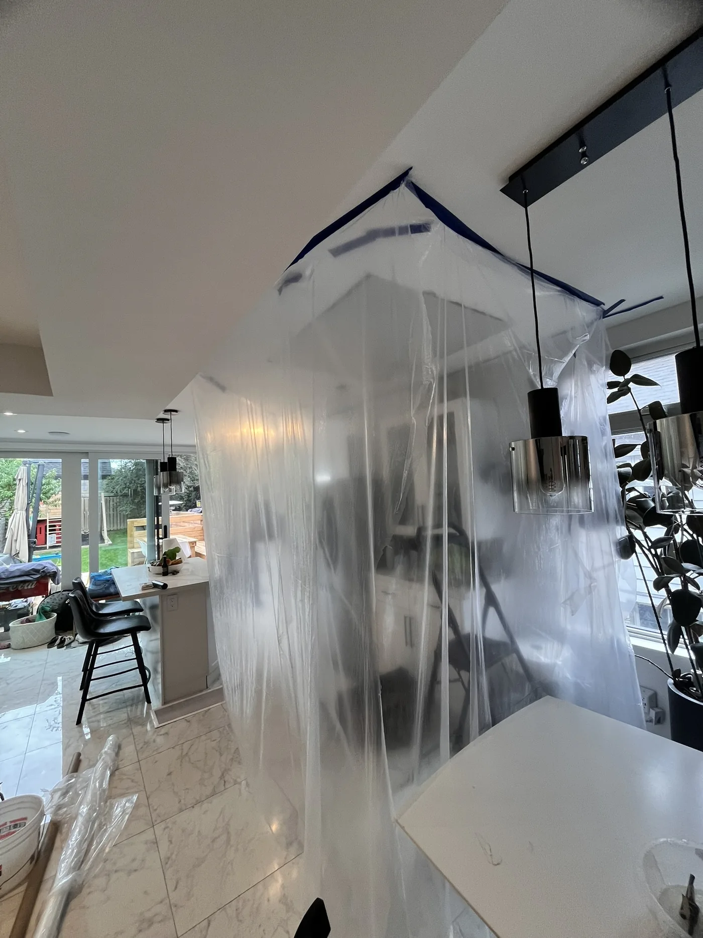 Kitchen enclosed with plastic for drywall ceiling repair