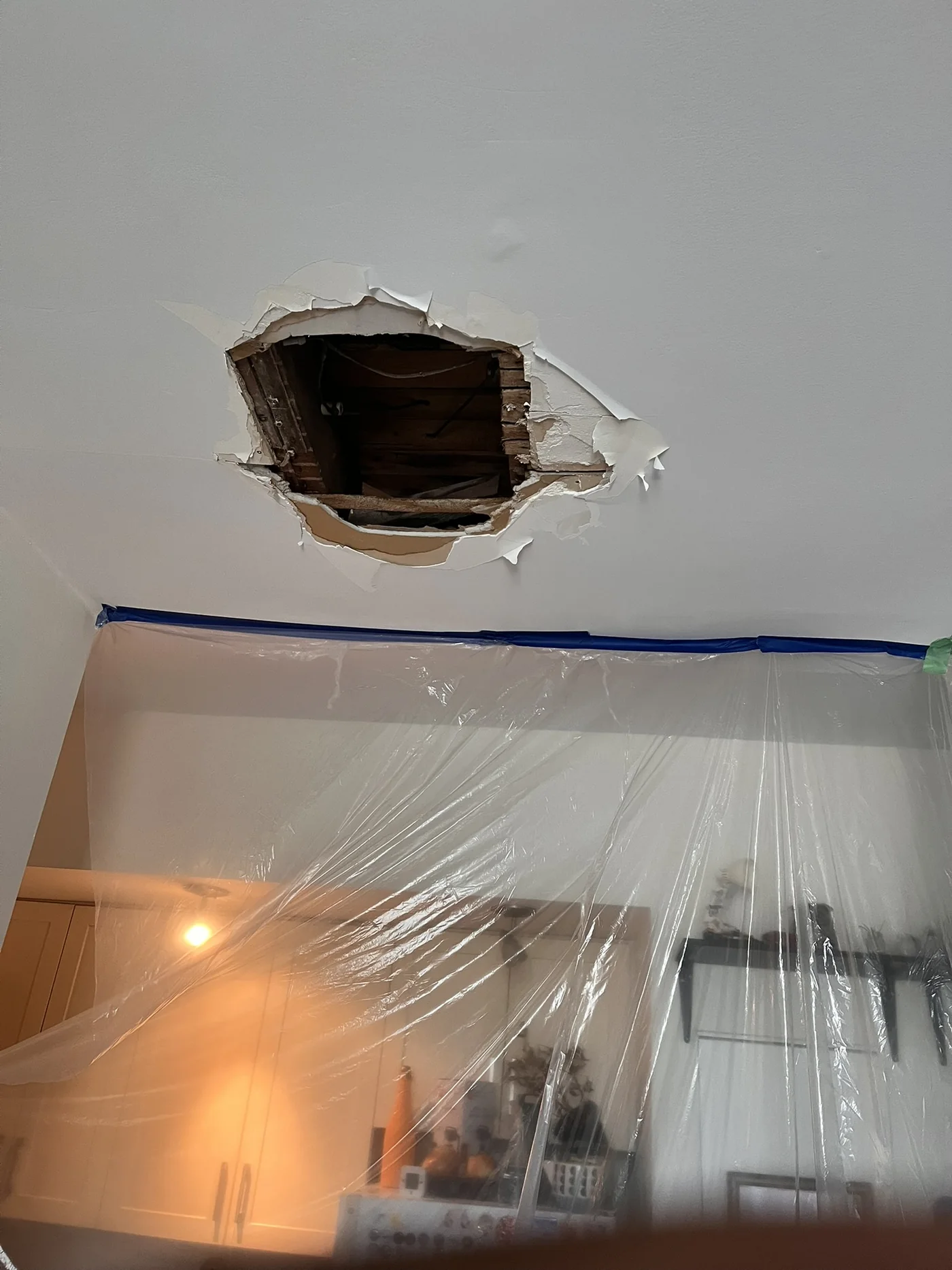 Damaged living room ceiling before drywall repair