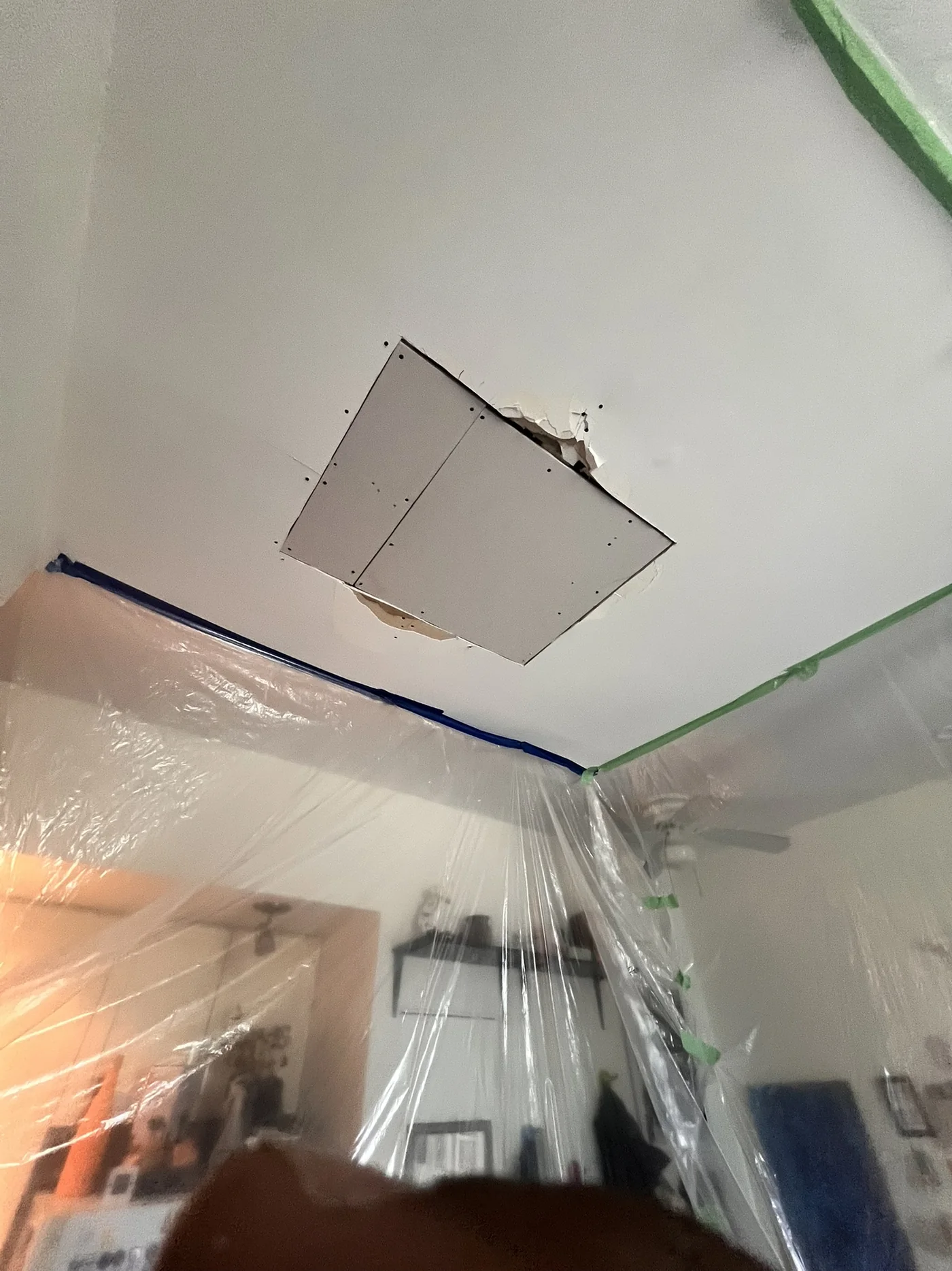 New drywall installed in ceiling repair area