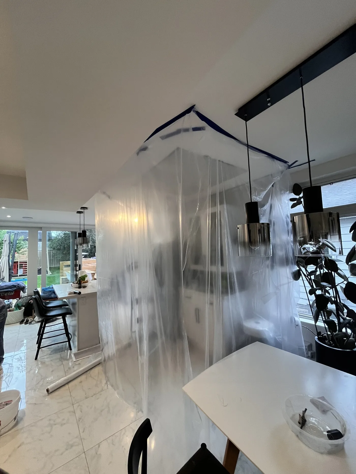Plastic dust protection around drywall repair area