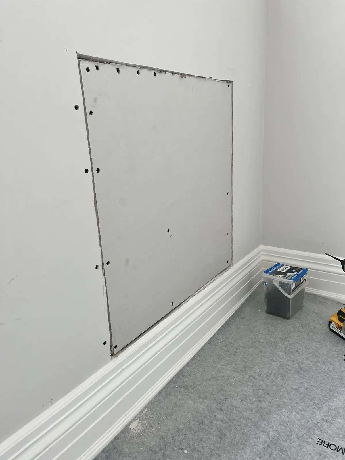 Drywall board installed over wall opening